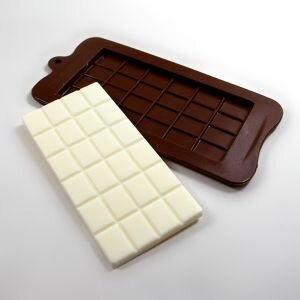 Silicone chocolate bar mould shown next to soap made using the mould in a contrasting colour.