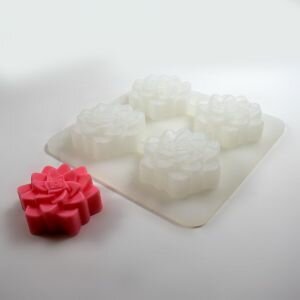 Silicone flower mould shown next to flower soap made using the mould.